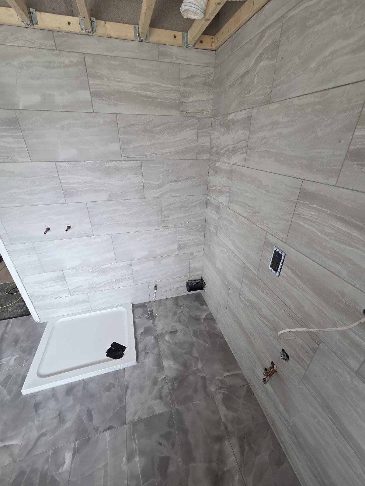 Second angle of grey large-format porcelain bathroom walls and floor